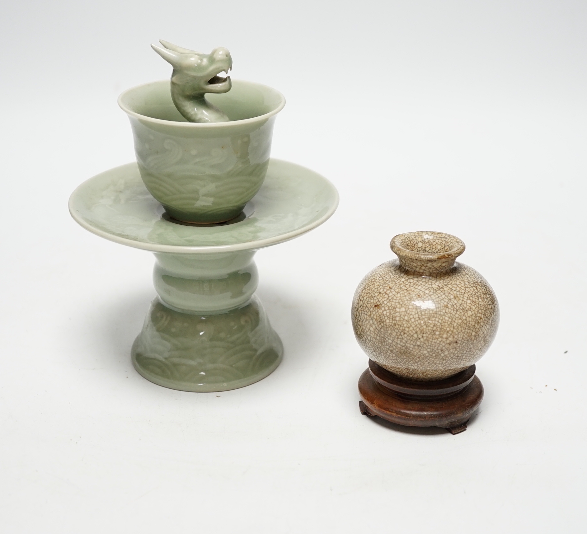 A Chinese celadon glazed 'dragon' puzzle cup and stand, early 20th century and a Chinese crackle glaze vase, 19th century, cup 7.5cm